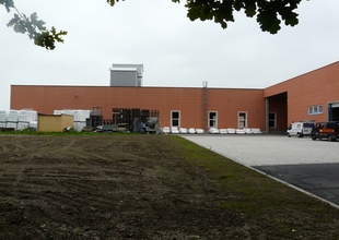 East view - existing manufacturing hall and the new warehouse